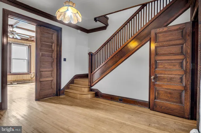a view of an empty room with a fireplace and windows