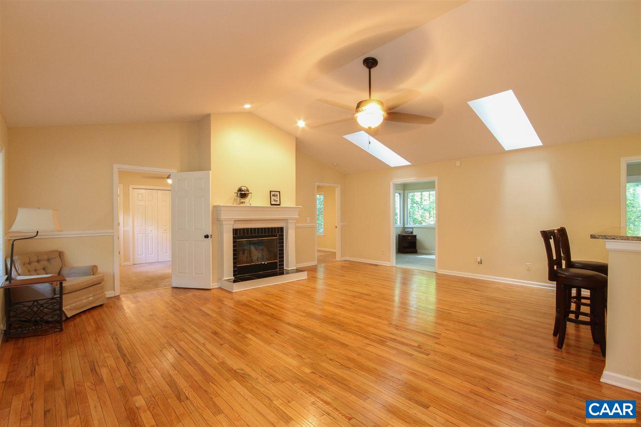 114 Riverside Drive Palmyra, VA 22963 - Photo 2 of 31 a view of a livingroom with a fireplace a chandelier and wooden floor