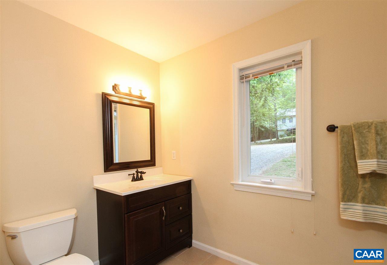 114 Riverside Drive Palmyra, VA 22963 - Photo 21 of 31 a bathroom with a toilet a sink a mirror and a window