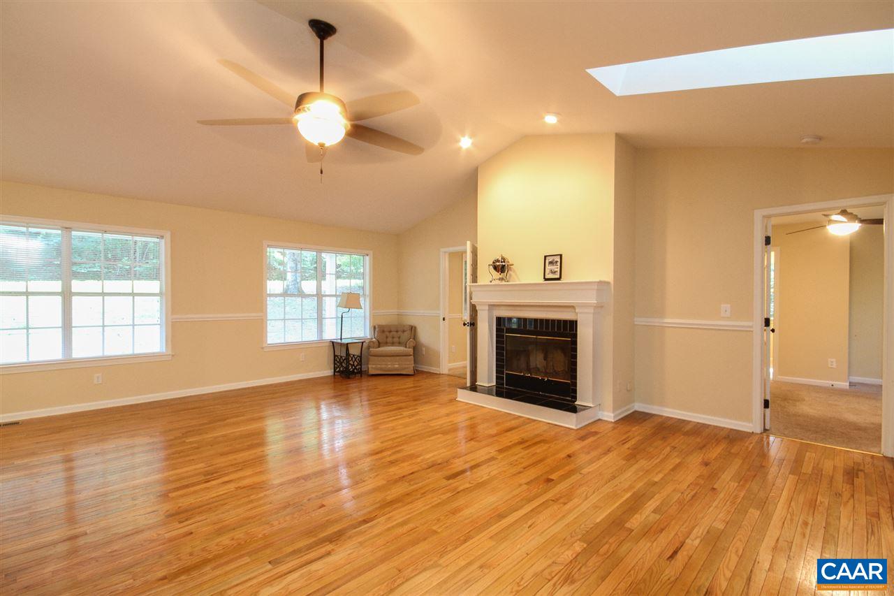 114 Riverside Drive Palmyra, VA 22963 - Photo 5 of 31 a view of a livingroom with a fireplace wooden floor and windows