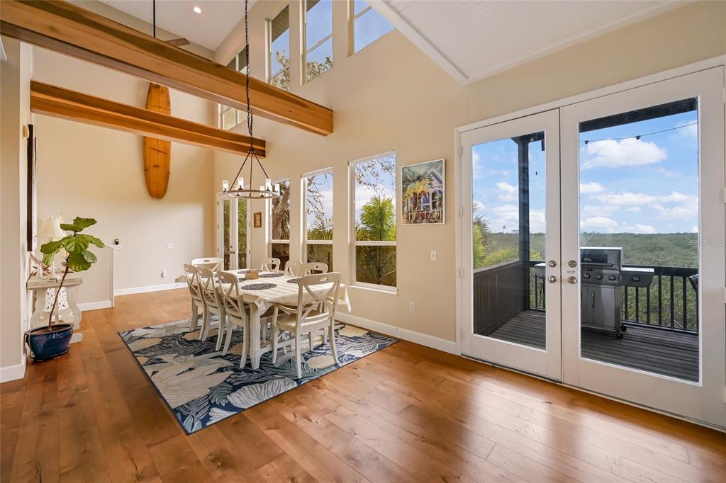 7325 Holly Road Terra Ceia, FL 34250 - Photo 15 of 87 a living room with furniture a large window and wooden floor