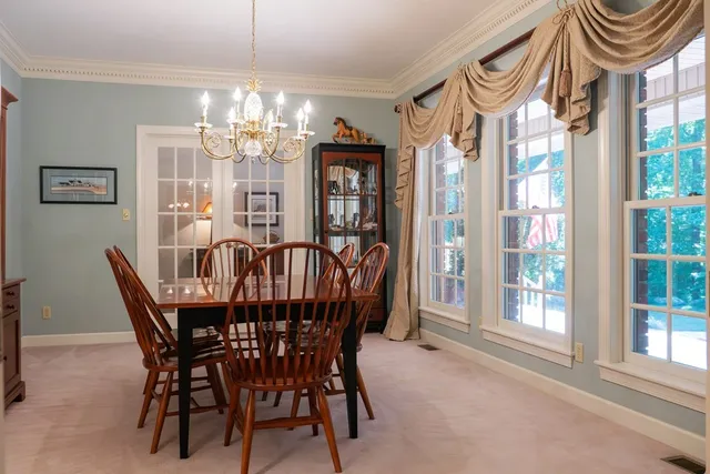 a view of a dining room with furniture window and chandelier
