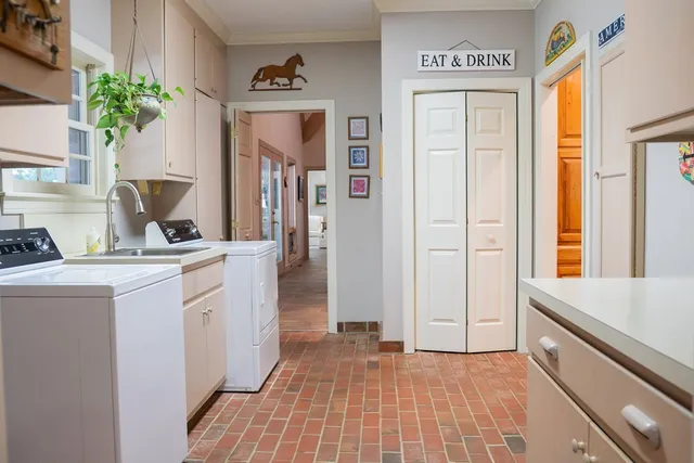 a utility room with closet dryer and washer