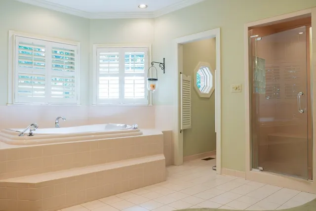 a bathroom with a tub sink and mirror