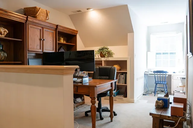 a view of a livingroom with a chair and a fireplace