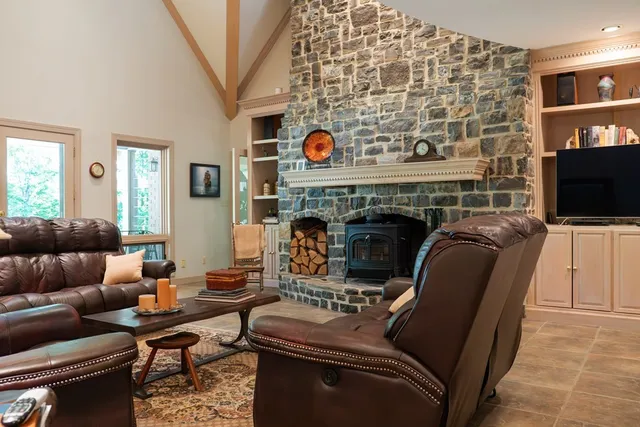 a living room with furniture a flat screen tv and a fireplace