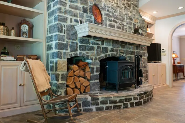 a view of a chairs and table in backyard of the house