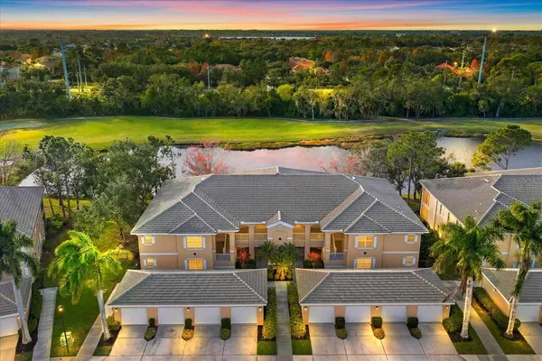 an aerial view of a house with a big yard and large trees