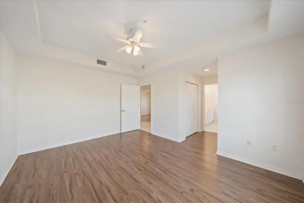 a view of an empty room with wooden floor
