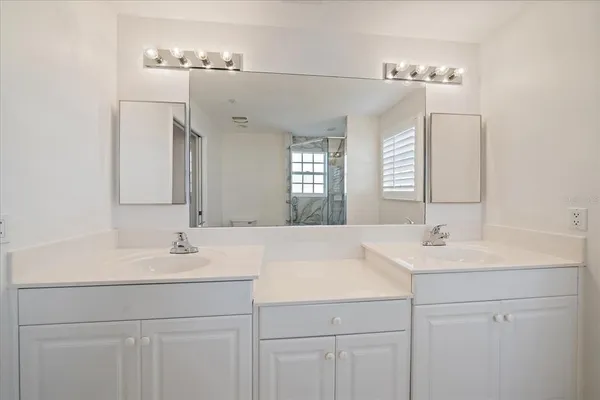 a bathroom with a sink vanity and a mirror