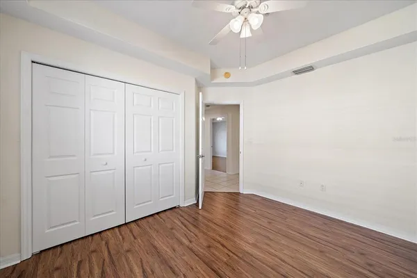 a view of an empty room with wooden floor