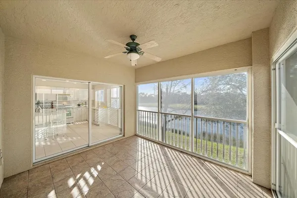 a view of a room with wooden floor and windows