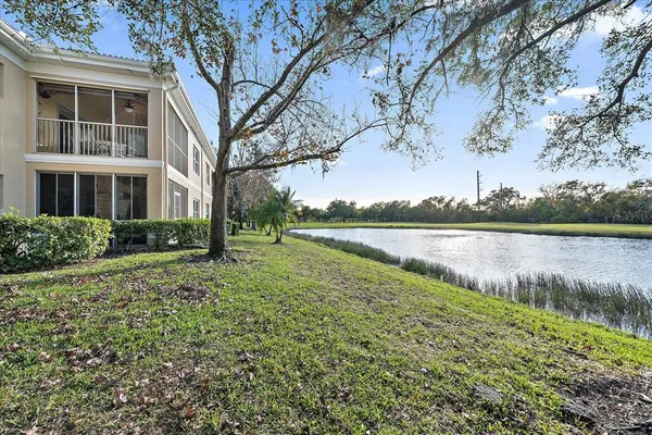 a view of a house with a yard and lake view