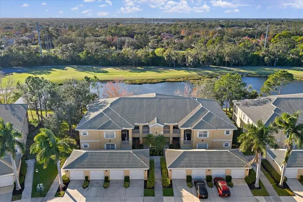 an aerial view of a house with a swimming pool lake view and mountain view