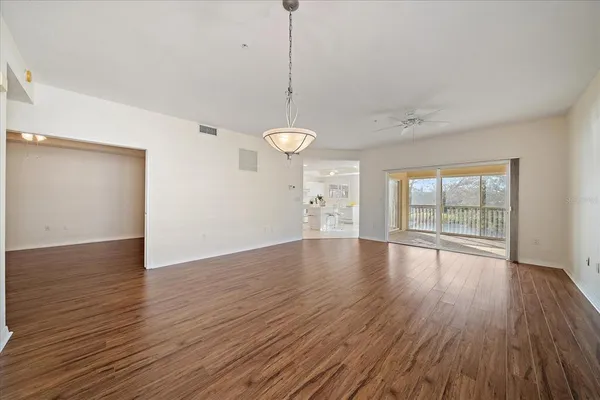 a view of a room with wooden floor and window