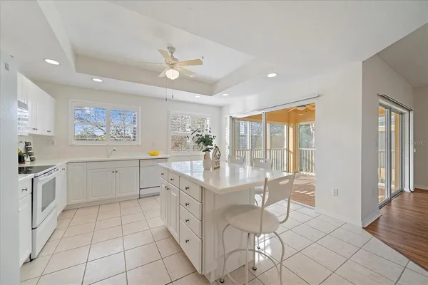 a large white kitchen with a large window