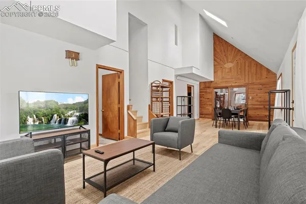 a dining room with furniture window and wooden floor