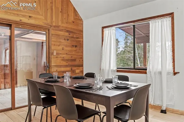 a view of a dining room with furniture and window