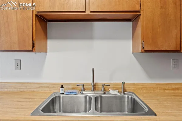 a kitchen with a sink and a stove top open