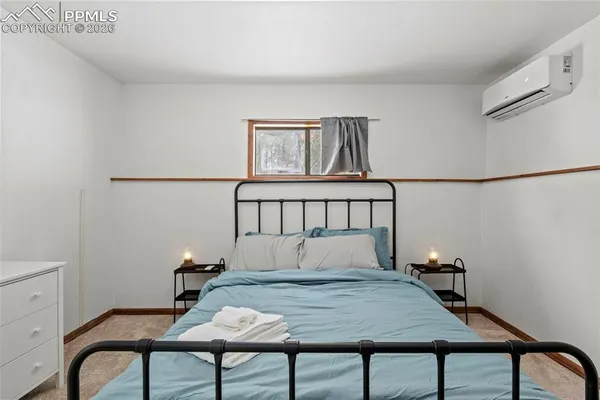 a bedroom with a bed and a view of bedroom