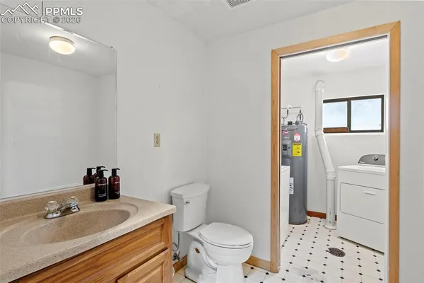a bathroom with a toilet a sink and a mirror