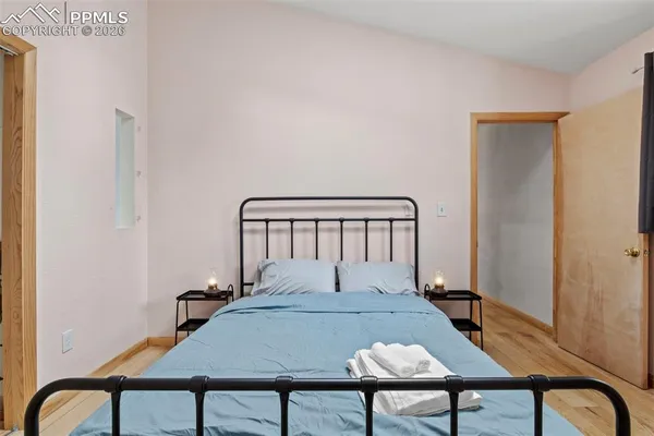 a bedroom with a bed and a large window