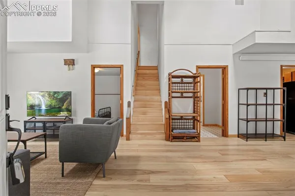 a view of a hallway with wooden floor and entryway