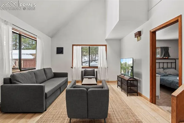 a living room with furniture and a flat screen tv