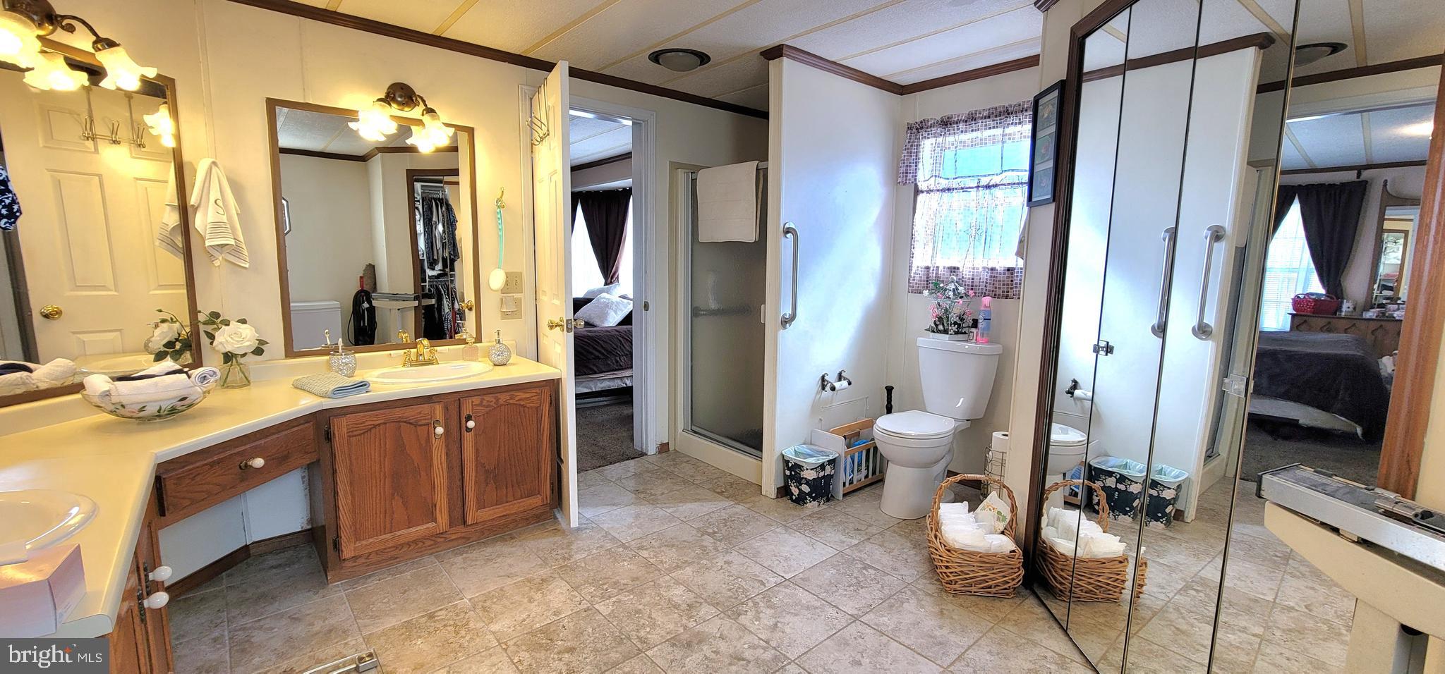 330 John Alden Drive Buena, NJ 08310 - Photo 12 of 16 a spacious bathroom with a granite countertop sink mirror and a bathtub