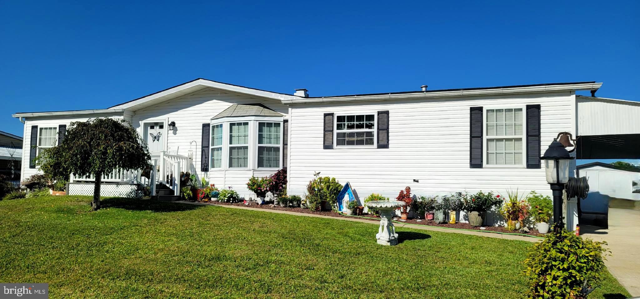 330 John Alden Drive Buena, NJ 08310 - Photo 14 of 16 a front view of a house with a garden