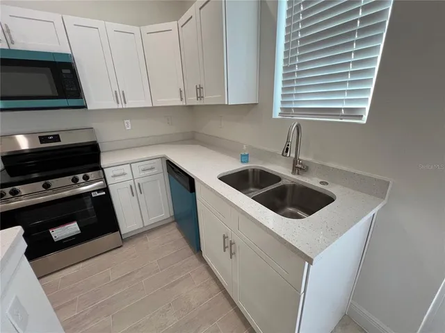a kitchen with a stove and a sink
