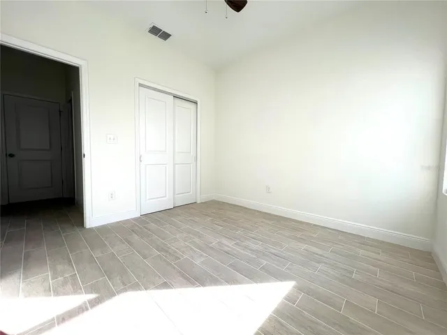 a view of an empty room and wooden floor
