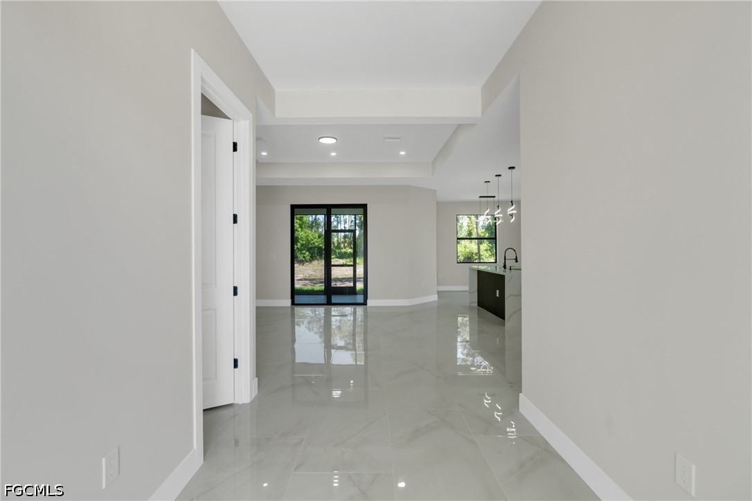 507 Trinity Street East Lehigh Acres, FL 33974 - Photo 11 of 50 wooden floor in an empty room and a gallery