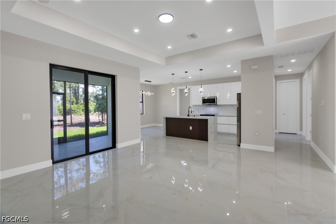 507 Trinity Street East Lehigh Acres, FL 33974 - Photo 13 of 50 a large kitchen with stainless steel appliances a large counter top