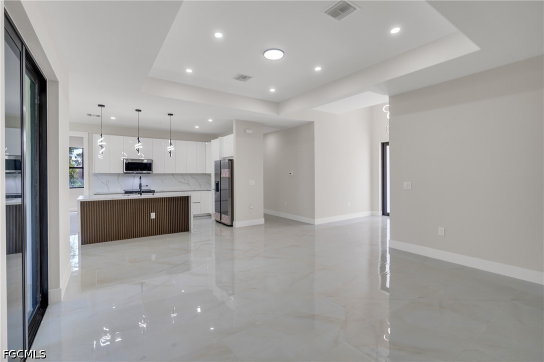 507 Trinity Street East Lehigh Acres, FL 33974 - Photo 15 of 50 a large kitchen with a sink and a refrigerator