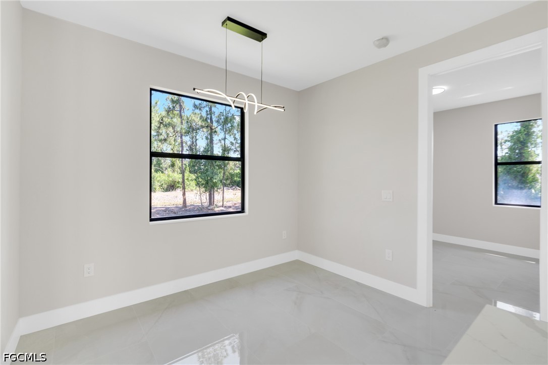 507 Trinity Street East Lehigh Acres, FL 33974 - Photo 25 of 50 a view of an empty room with a window