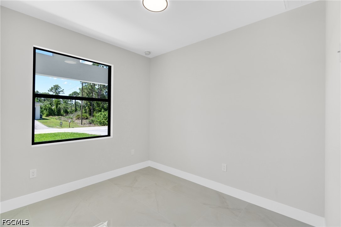 507 Trinity Street East Lehigh Acres, FL 33974 - Photo 30 of 50 an empty room with a window