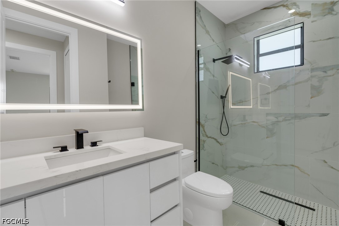 507 Trinity Street East Lehigh Acres, FL 33974 - Photo 31 of 50 a bathroom with a sink toilet and shower