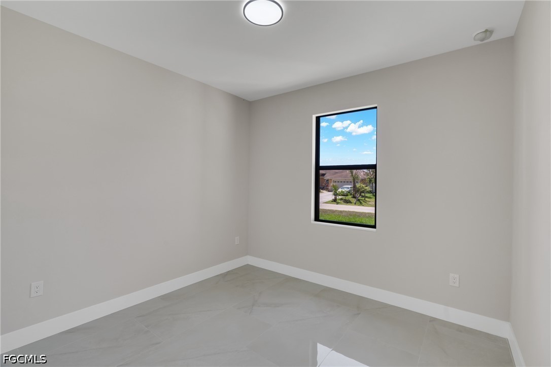 507 Trinity Street East Lehigh Acres, FL 33974 - Photo 32 of 50 a view of an empty room with a window