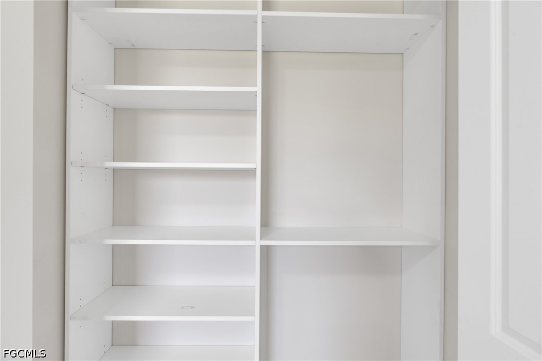 507 Trinity Street East Lehigh Acres, FL 33974 - Photo 34 of 50 a view of walk in closet with empty racks