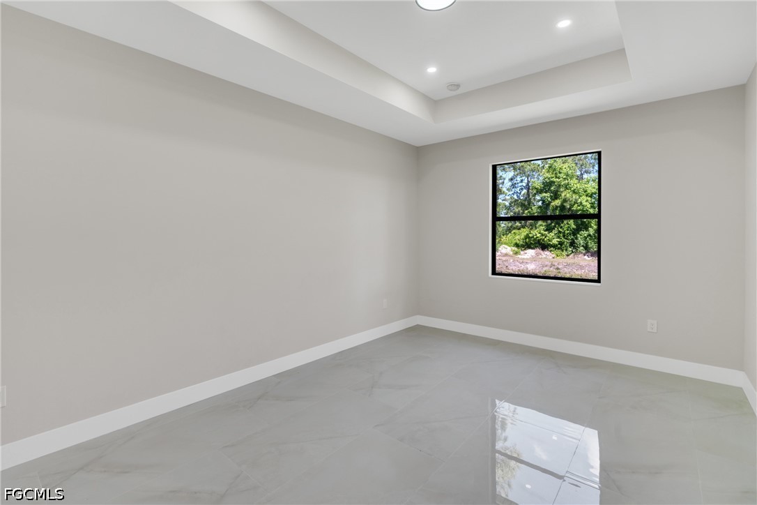 507 Trinity Street East Lehigh Acres, FL 33974 - Photo 37 of 50 an empty room with windows