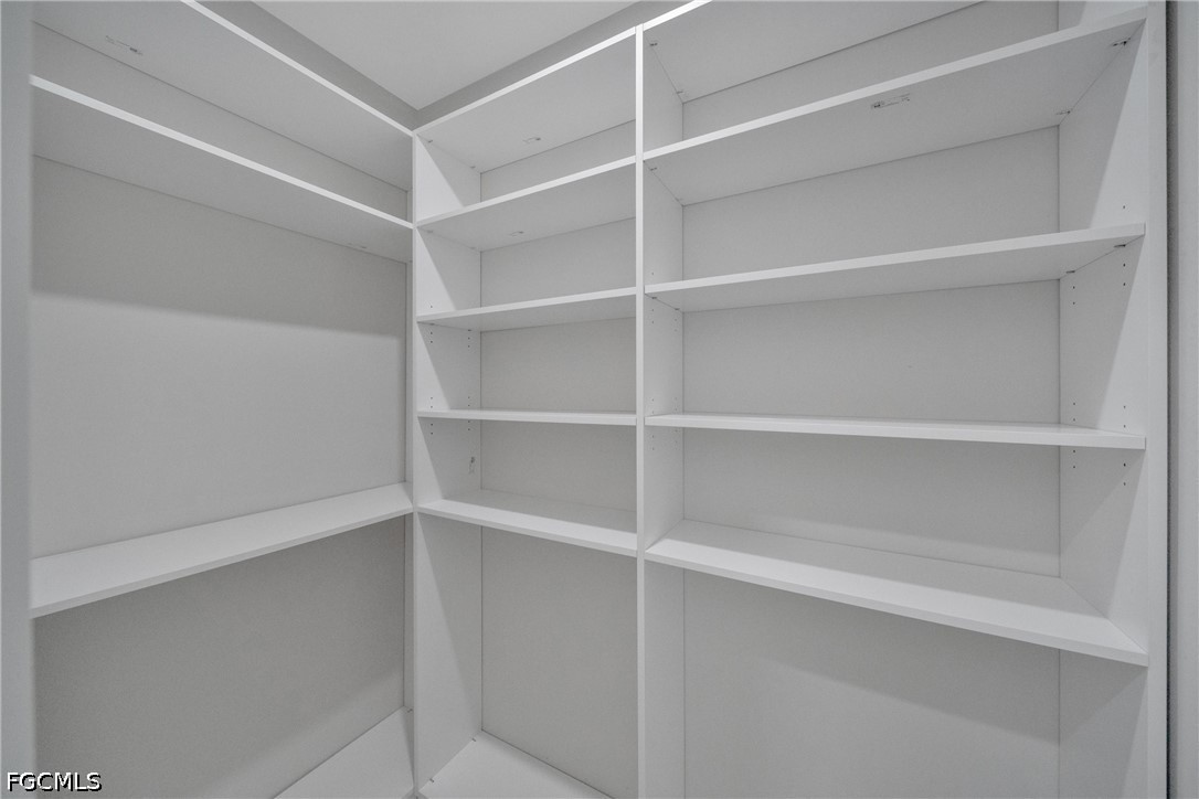 507 Trinity Street East Lehigh Acres, FL 33974 - Photo 40 of 50 a view of walk in closet with empty racks