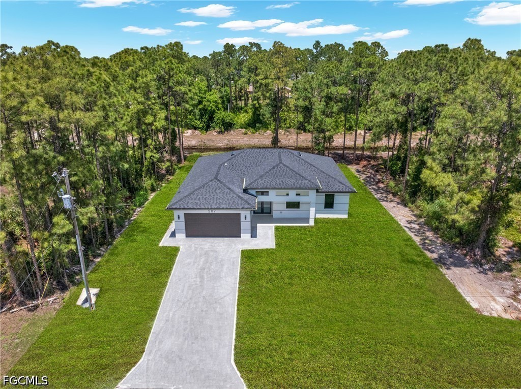 507 Trinity Street East Lehigh Acres, FL 33974 - Photo 4 of 50 an aerial view of a house