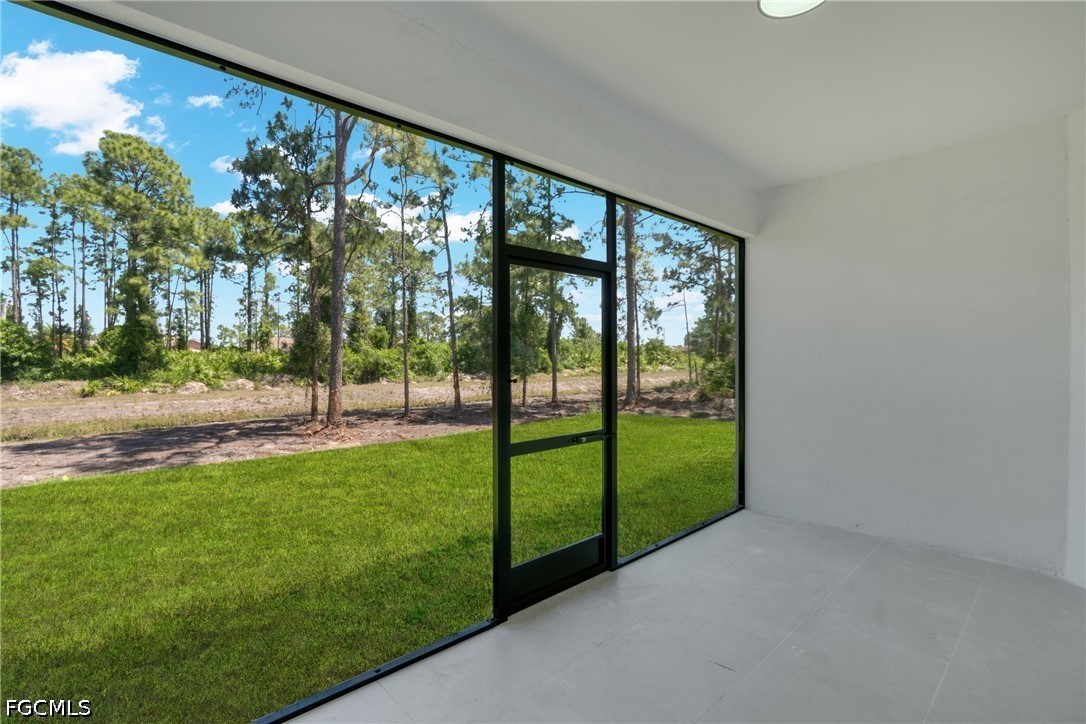 507 Trinity Street East Lehigh Acres, FL 33974 - Photo 42 of 50 a view of a yard with a tree