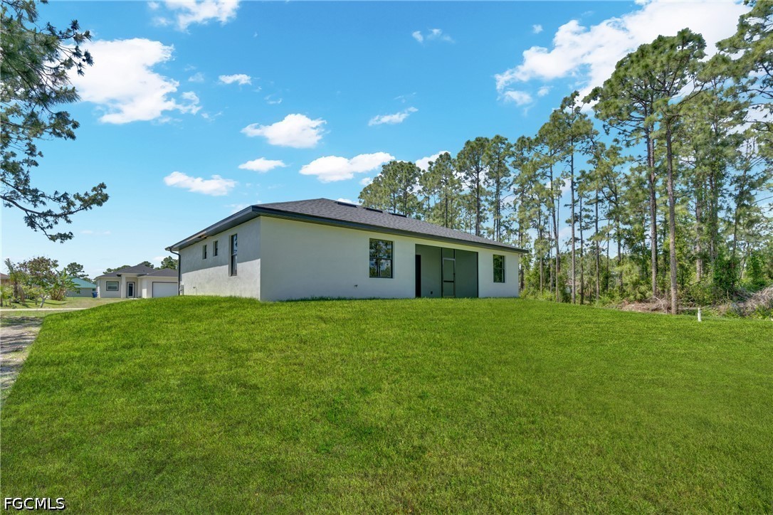 507 Trinity Street East Lehigh Acres, FL 33974 - Photo 43 of 50 a house view with a garden space