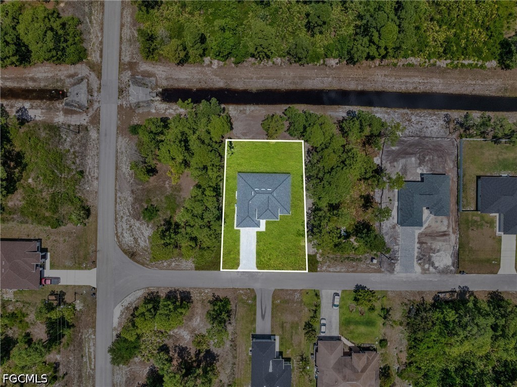 507 Trinity Street East Lehigh Acres, FL 33974 - Photo 47 of 50 an aerial view of a house with a yard