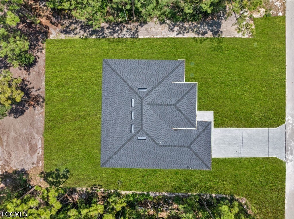 507 Trinity Street East Lehigh Acres, FL 33974 - Photo 49 of 50 a view of a garden with an outdoor space