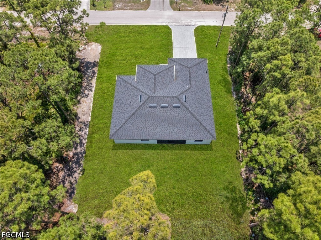 507 Trinity Street East Lehigh Acres, FL 33974 - Photo 50 of 50 a aerial view of a house with garden space and trees