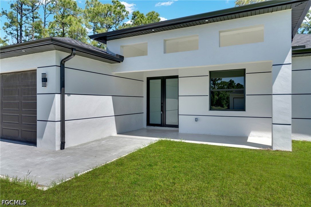507 Trinity Street East Lehigh Acres, FL 33974 - Photo 10 of 50 a view of house with backyard