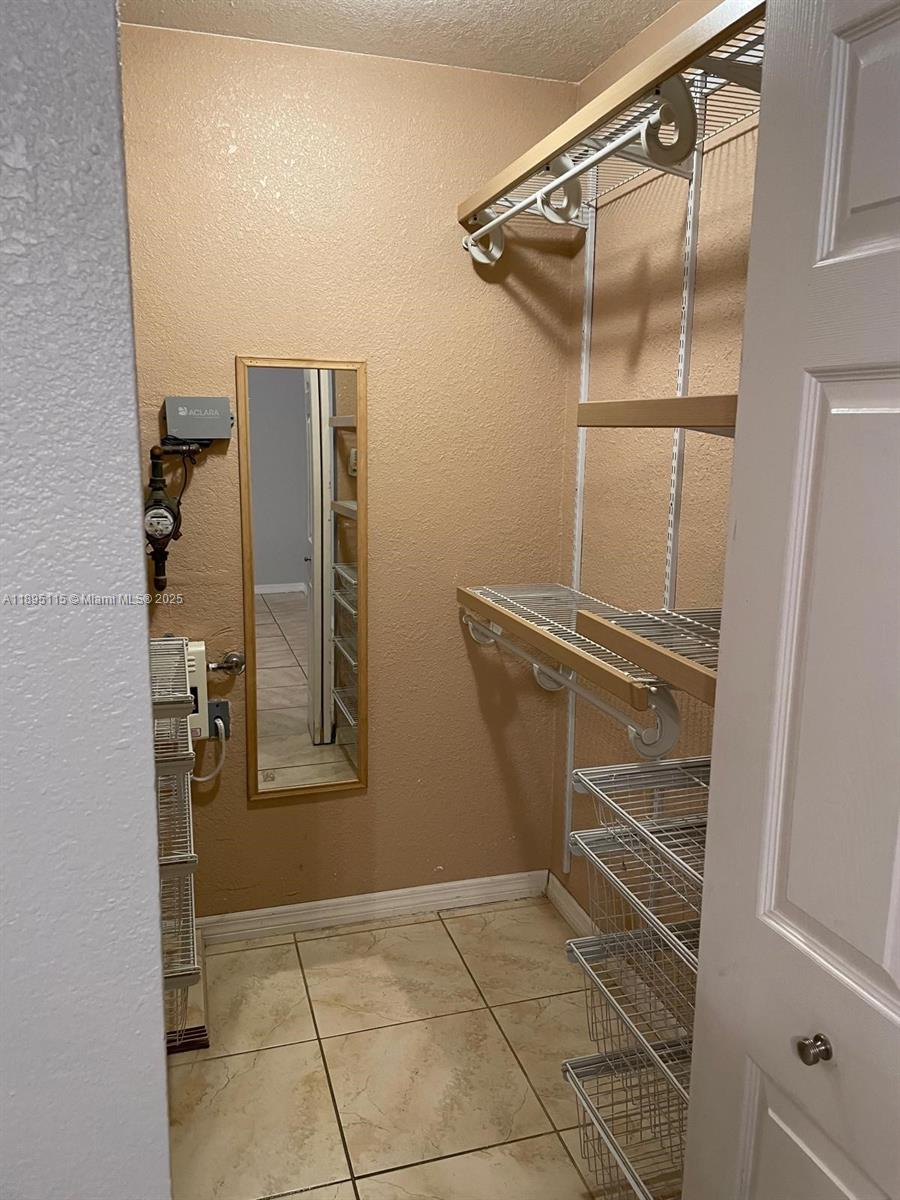 8100 Geneva Court, Unit 440 Doral, FL 33166 - Photo 8 of 11 a view of walk in closet with empty racks